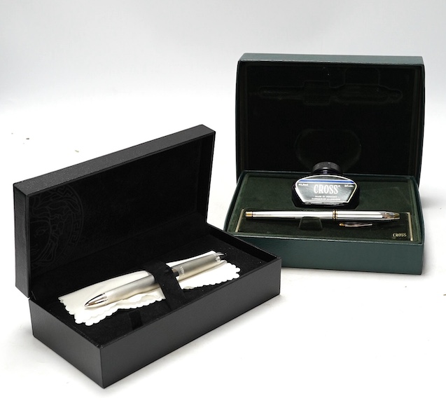 Two boxed pens; a Versace and a Cross, both with outer cardboard boxes. Condition - Versace pen good, display box good, outer box damaged. Cross pen good, ink bottle good, case damaged